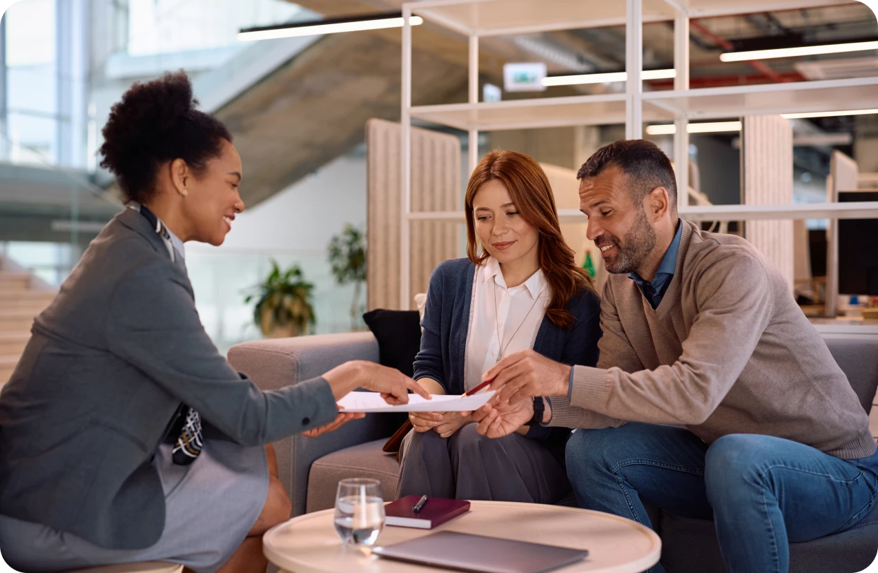 Business meeting with three people smiling