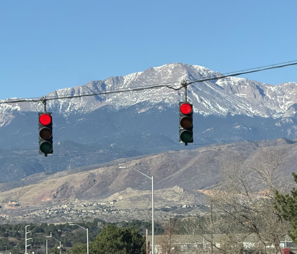Pikes Peak with Colorado Springs traffic lights at red — the cost of waiting on a mortgage decision