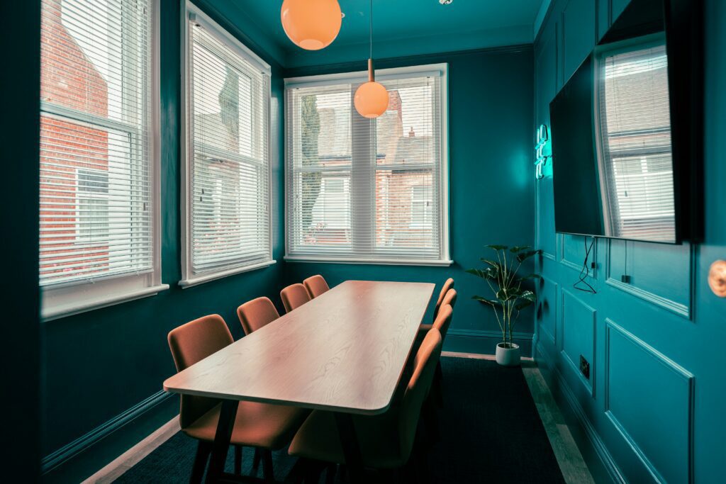 Empty restaurant table with a leather-bound folder and a pen, suggesting a sales meeting setup