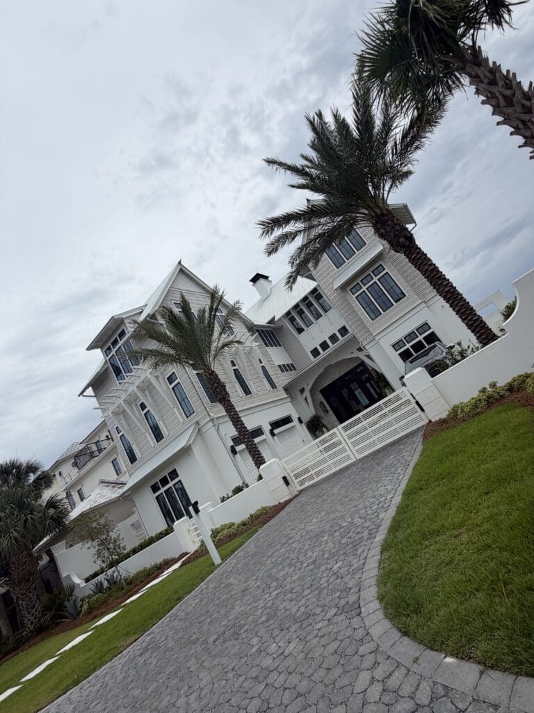 Coastal white mansion with palm trees